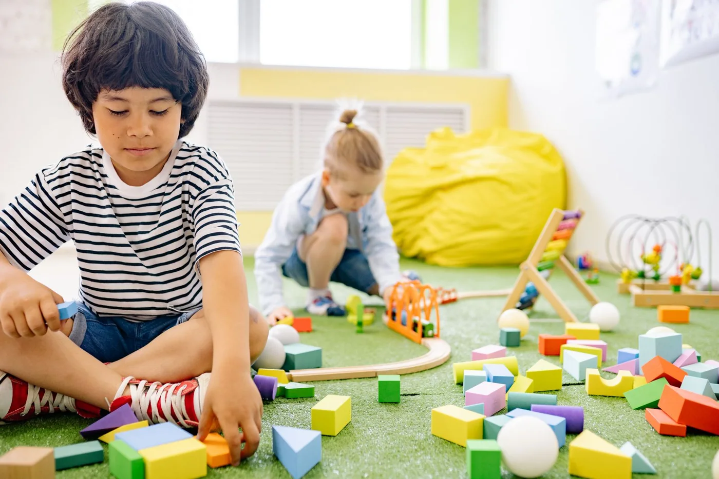 Illustrative photograph: Children discovering and building with wooden blocks